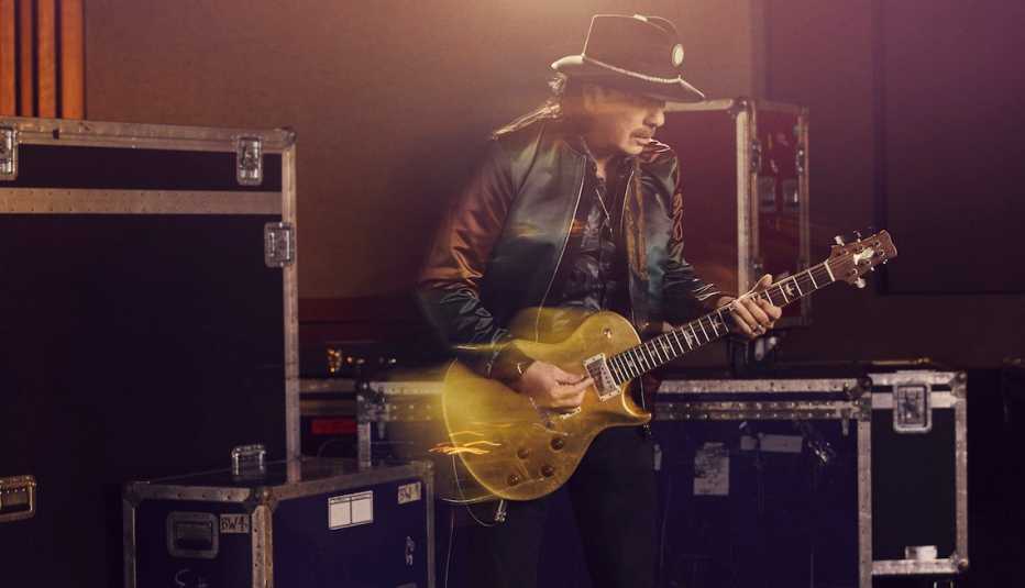 Carlos Santana playing a guitar