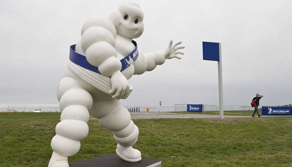Michelin man on a skate board outside