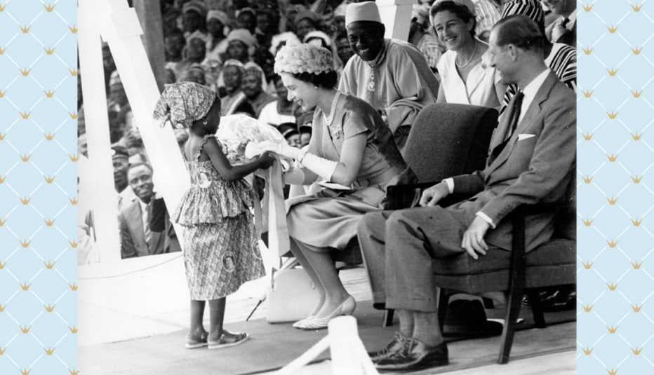 Queen Elizabeth II receives a bouquet from a young girl during a Royal Tour of Sierra Leone in 1961