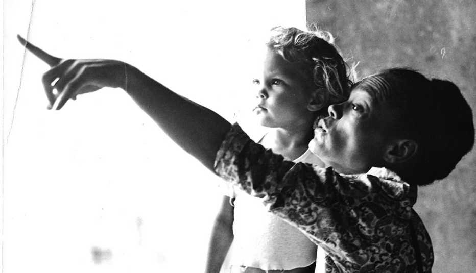 A black and white photo of Kitt Shapiro as a child with her mother Eartha Kitt