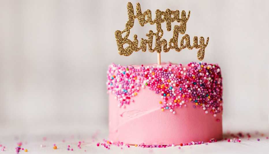 pink Birthday cake with happy birthday sign 