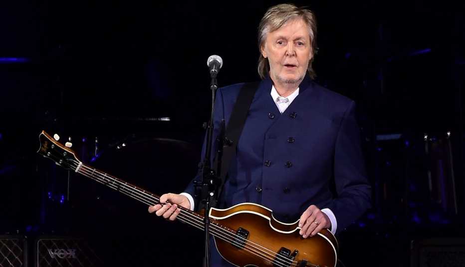 Paul McCartney holding his instrument onstage at his concert during his Got Back tour stop at SoFi Stadium in Inglewood, California