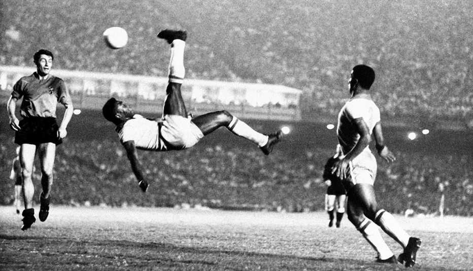 Pele performs a bicycle kick during a soccer game in 1968