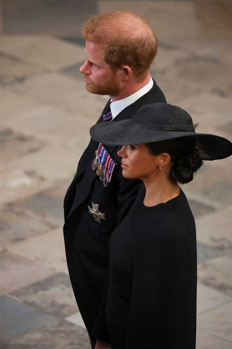 Britain's Prince Harry, Duke of Sussex and Meghan, Duchess of Sussex (R) attend the State Funeral Service for Britain's Queen Elizabeth II