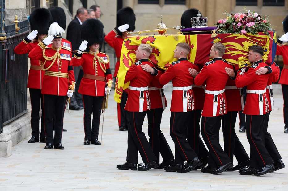 A Bearer Party of The Queen's Company, 1st Battalion Grenadier Guards places the coffin of Queen Elizabeth II onto the State Gun Carriage of the Royal Navy outside of Westminster Hall
