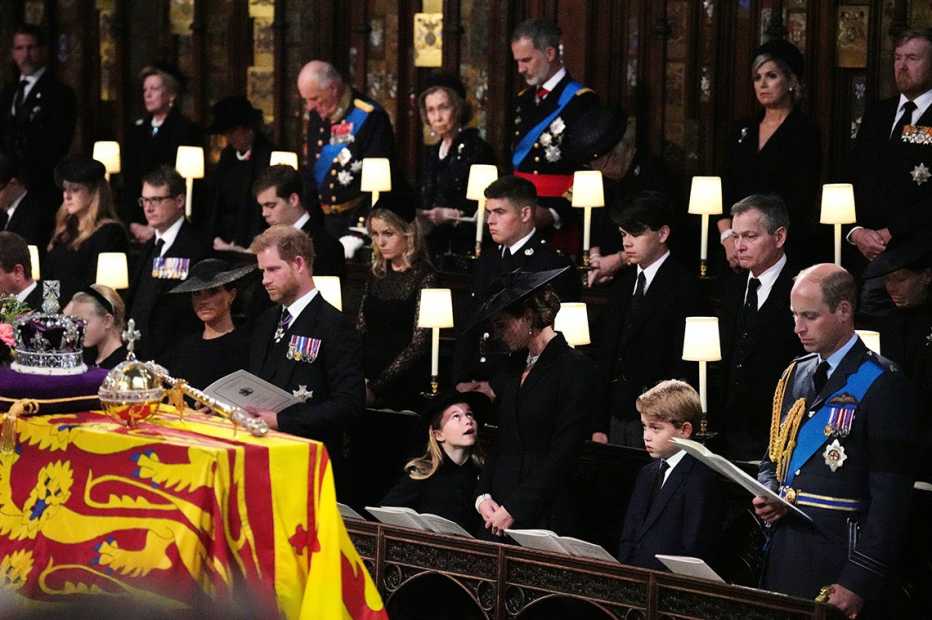 Prince Harry, Duke of Sussex, Princess Charlotte of Wales, Catherine, Princess of Wales, Prince George of Wales, and Prince William, Prince of Wales, watch as the Imperial State Crown and the Sovereign's orb and sceptre are removed from the coffin of Queen Elizabeth II, draped in the Royal Standard, during the Committal Service at St George's Chapel on September 19, 2022 in Windsor, England. The committal service at St George's Chapel, Windsor Castle, took place following the state funeral at Westminster Abbey. A private burial in The King George VI Memorial Chapel followed. Queen Elizabeth II died at Balmoral Castle in Scotland on September 8, 2022, and is succeeded by her eldest son, King Charles III