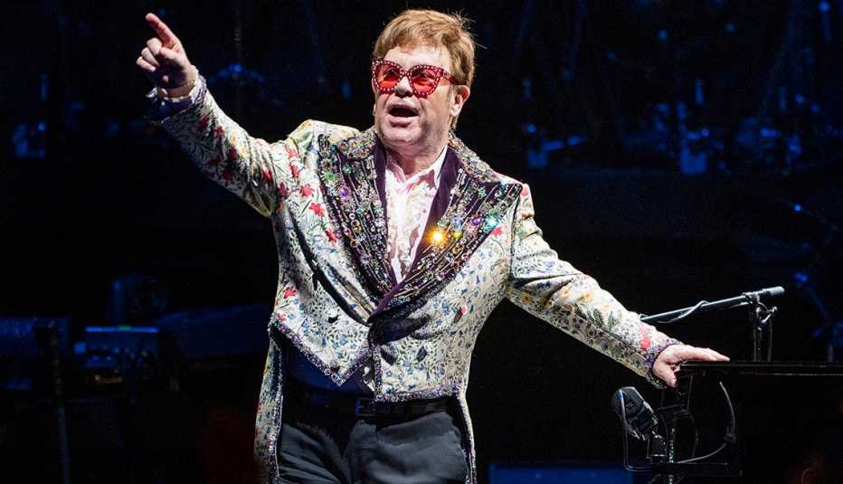 Elton John points to the crowd onstage during his Farewell Yellow Brick Road Tour