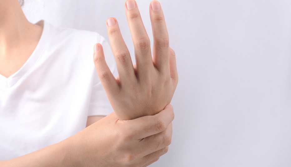 woman holding her wrist due to numbness