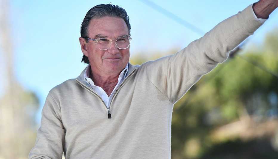 Jimmy Connors waves while appearing onstage at the One 805 Kick Ash Bash benefitting First Responders