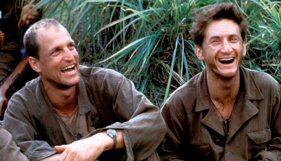 Woody Harrelson and Sean Penn laughing on the set of the film The Thin Red Line