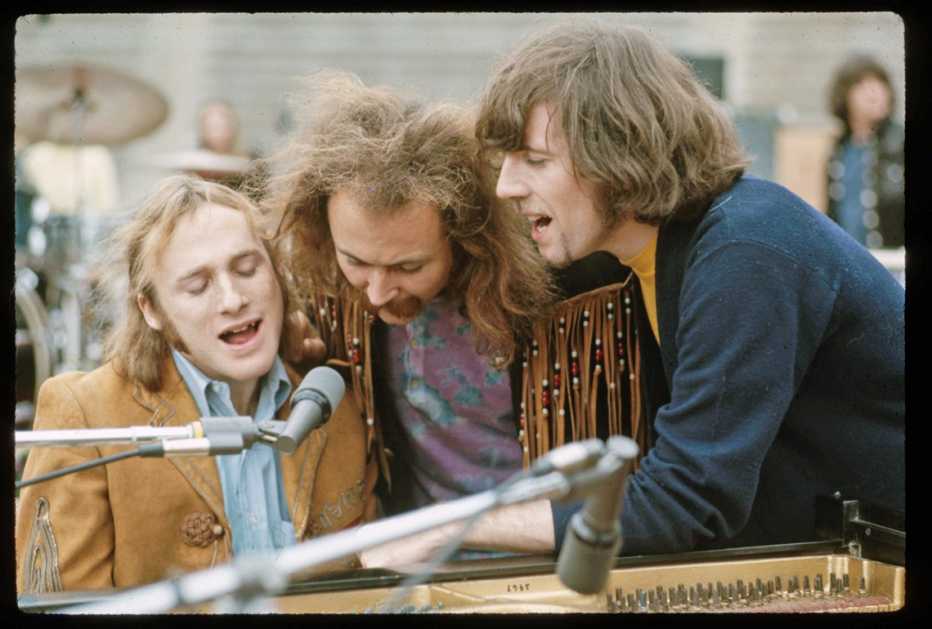 Folk-rockers Crosby, Stills, and Nash sing together on stage