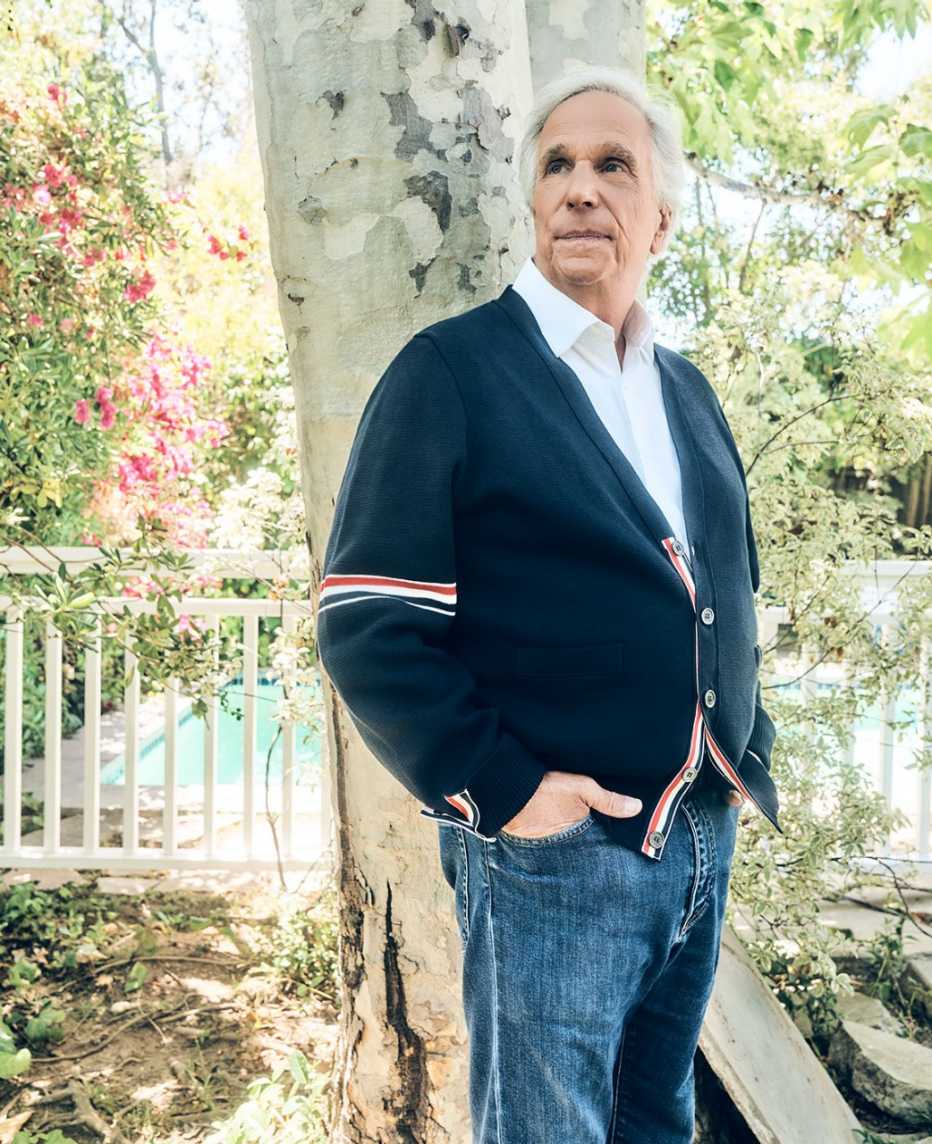 actor and writer henry winkler standing under a birch tree