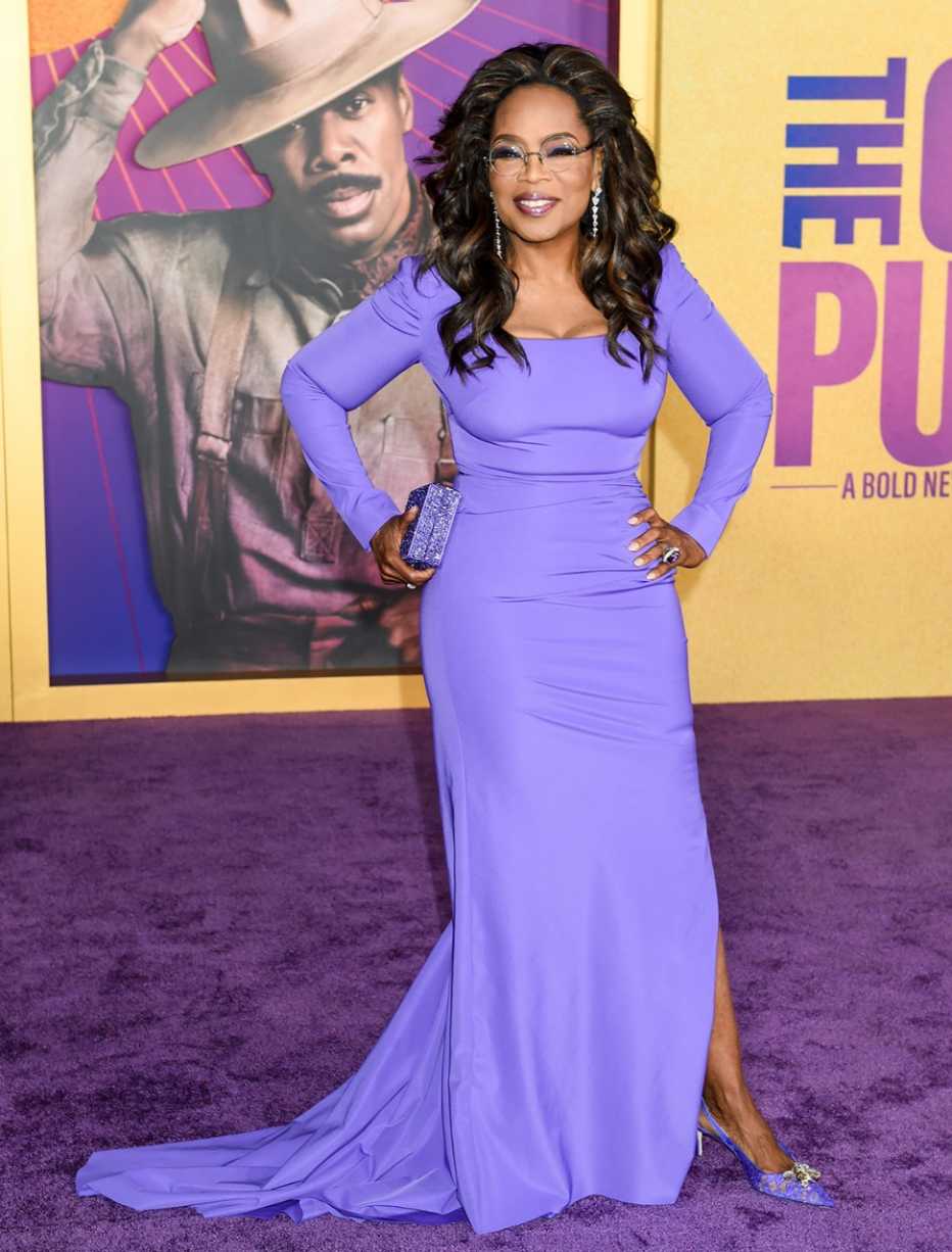 oprah winfrey at the color purple premiere  in december twenty twenty three wearing a purple dress