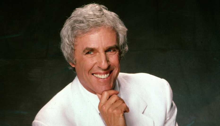 Composer Burt Bacharach in a white suit jacket posing for a portrait in 1987 in Los Angeles