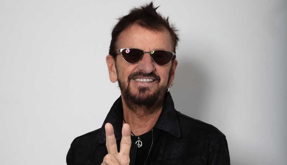 Musician Ringo Starr giving the peace sign