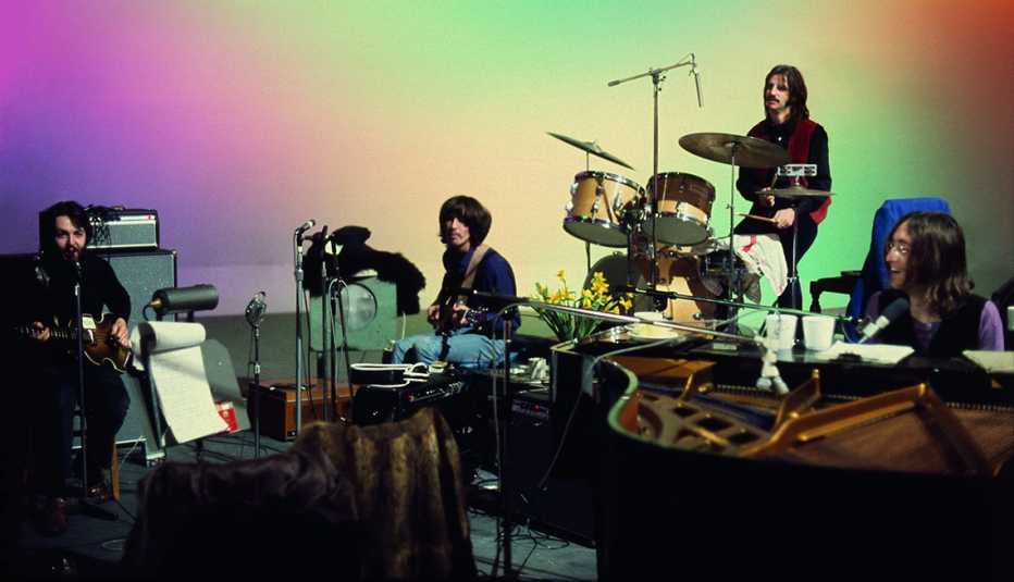 Paul McCartney, George Harrison, Ringo Starr and John Lennon performing in a studio