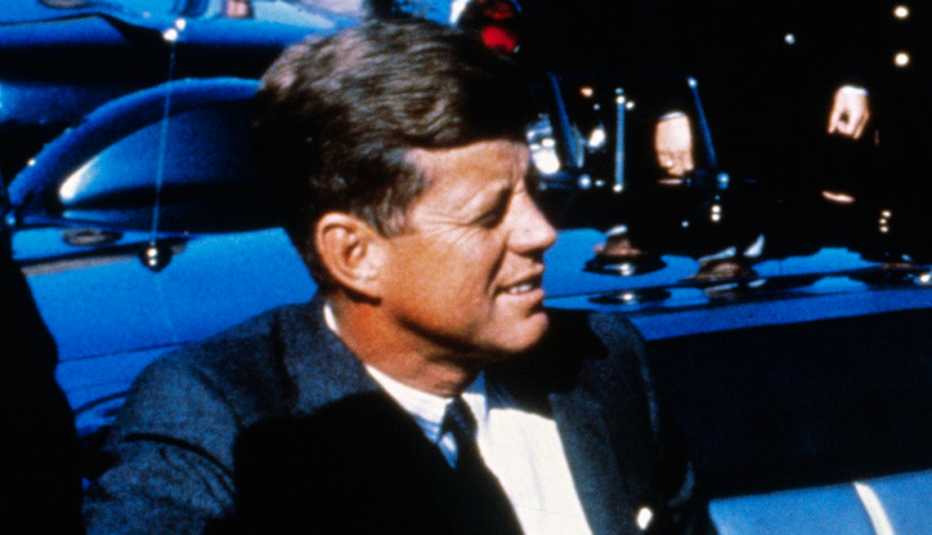 President John F. Kennedy riding in a motorcade from the Dallas airport into the city.