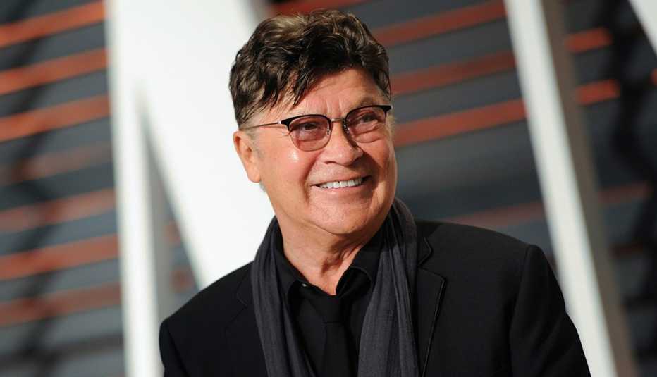 robbie robertson smiles on the red carpet at the vanity fair oscar party in beverly hills california