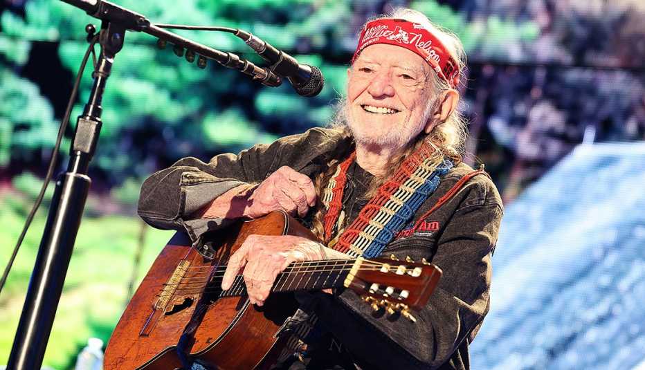 Willie Nelson smiles onstage during his performance at Farm Aid