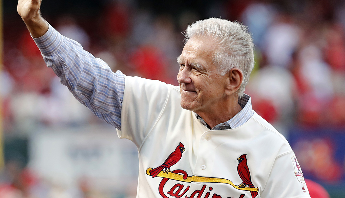 Tim McCarver waves to the crowd as he takes part in a ceremony honoring the 50th anniversary of the St. Louis Cardinals 1967 World Series championship team