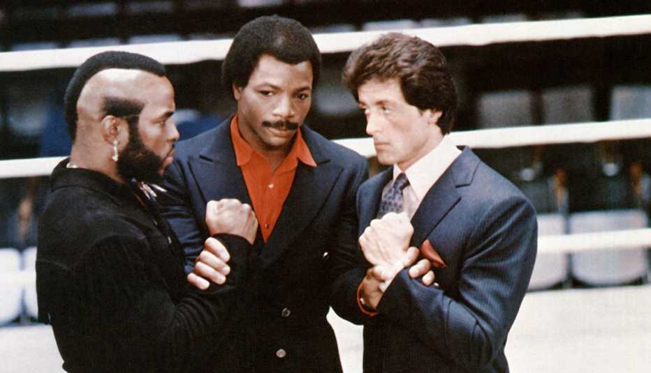 Mr. T, Carl Weathers and Sylvester Stallone standing in a boxing ring in "Rocky III."