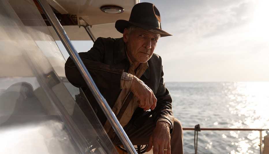 harrison ford kneeling on a boat in the film indiana jones and the dial of destiny
