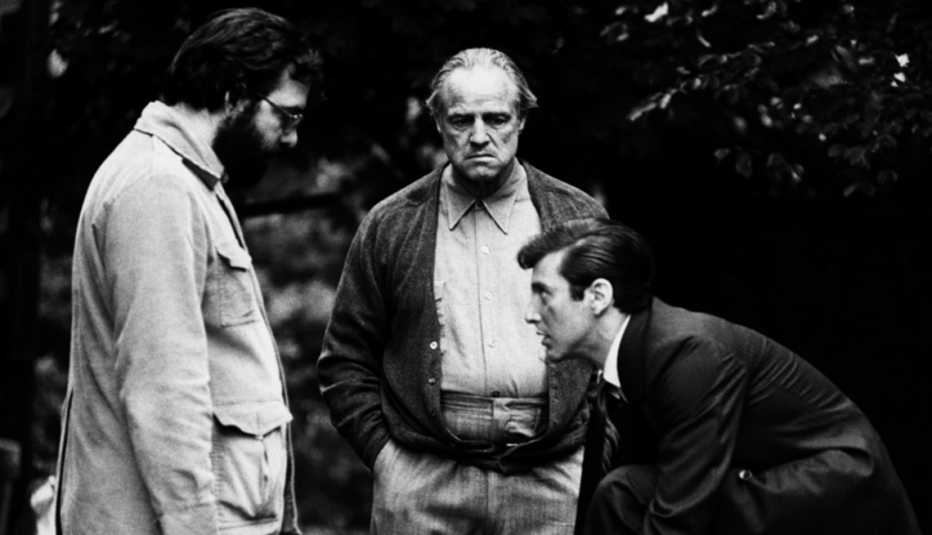 Director Francis Ford Coppola with actors Al Pacino and Marlon Brando on set of 'The Godfather' film.