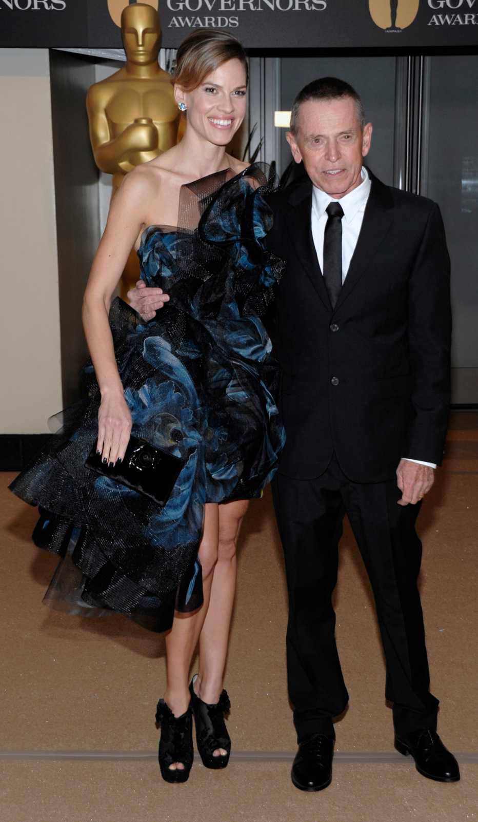 Hilary Swank standing next to her father.