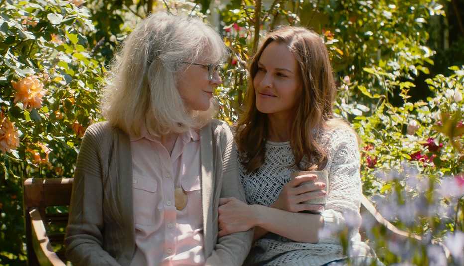 Blythe Danner and Hilary Swank sitting on a bench in "What They Had."