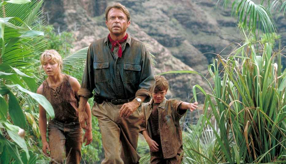 Actor Sam Neill as Dr. Alan Grant, with Ariana Richards (left) and Joseph Mazzello (right) as Lex and Tim, in a scene from the film 'Jurassic Park', 199