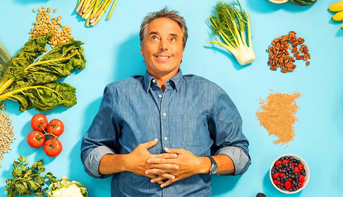 Dan Buettner surrounded by healthy food