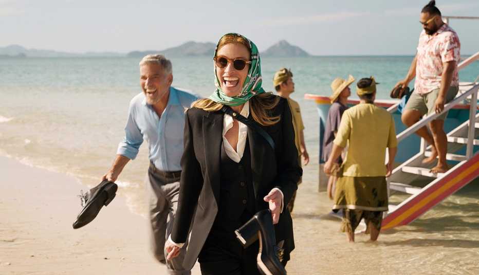 George Clooney and Julia Roberts arrive on a beach in the film Ticket to Paradise