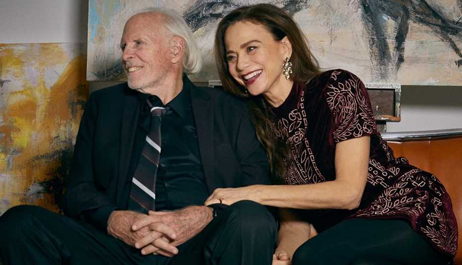 Bruce Olin and Lena Olin sitting together and smiling in a scene from The Artist's Wife