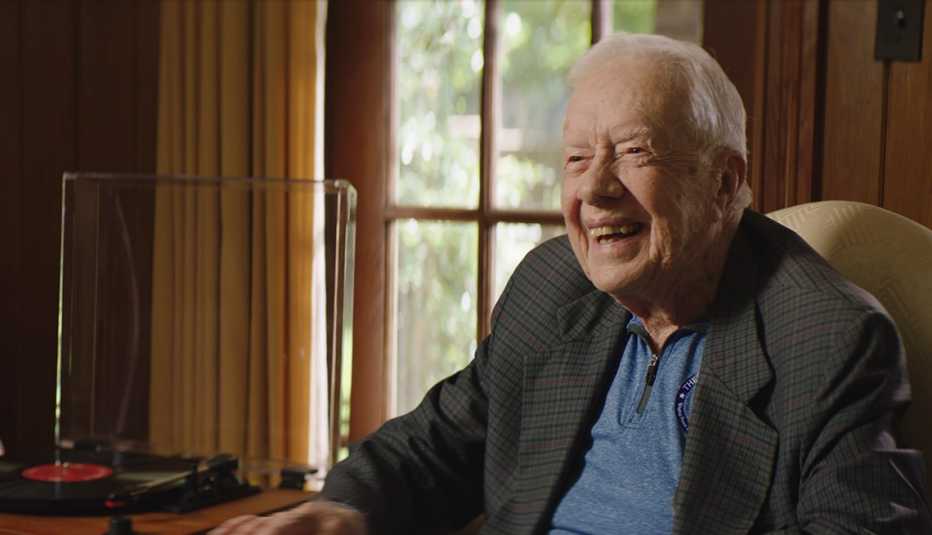 Former U S President Jimmy Carter sitting next to a record player while being interviewed for the documentary Jimmy Carter Rock and Roll President
