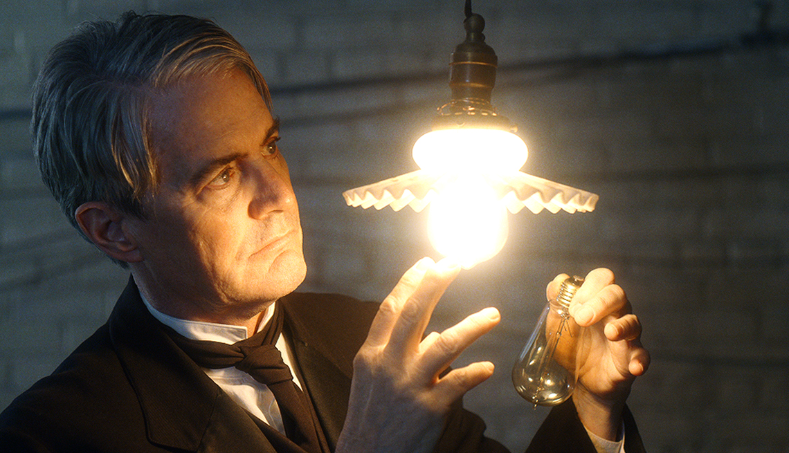 Kyle MacLachlan looks at a light bulb as he stars as Thomas Edison in the film Tesla