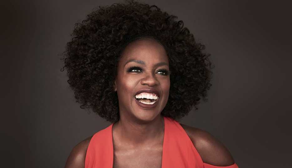 closeup of viola davis smiling during a photo shoot wearing a red jumpsuit