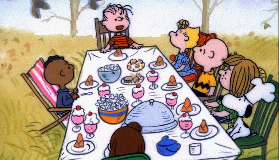 Charlie Brown and his friends sit around the dinner table in a scene from A Charlie Brown Thanksgiving