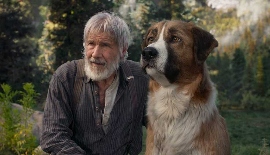 harrison ford alongside a dog in a still from the film call of the wild 