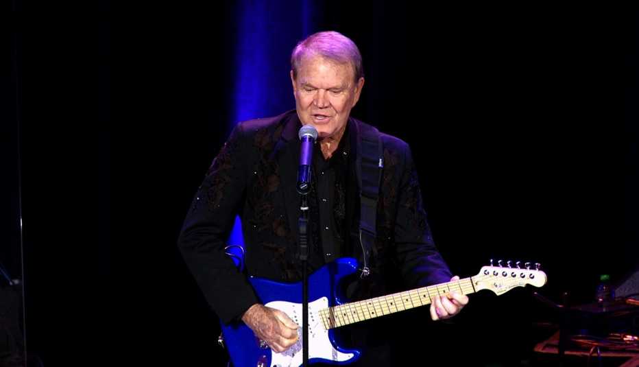 Glen Campbell performing on stage with his guitar in the documentary Glen Campbell: I'll Be Me
