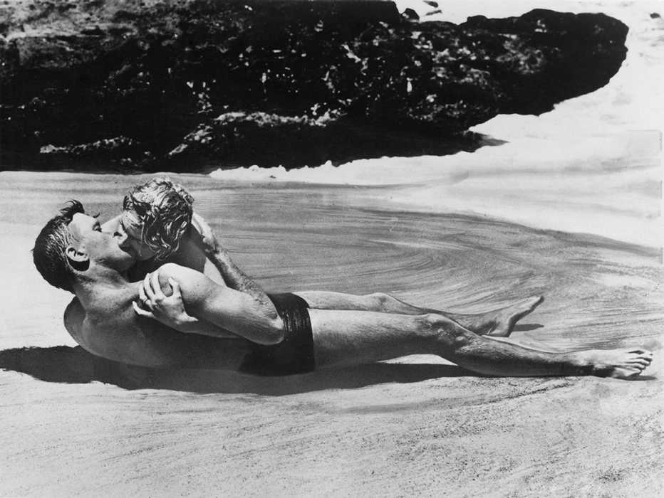 Burt Lancaster and Deborah Kerr kiss on a beach in the film From Here to Eternity