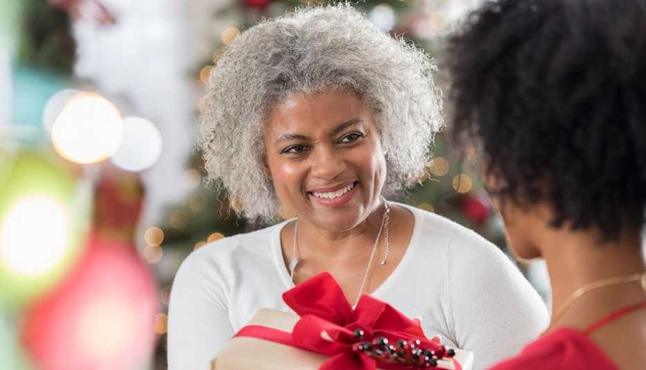 A woman is receiving a holiday present