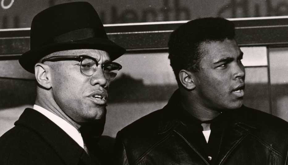 Malcolm X and Muhammad Ali standing next to each other