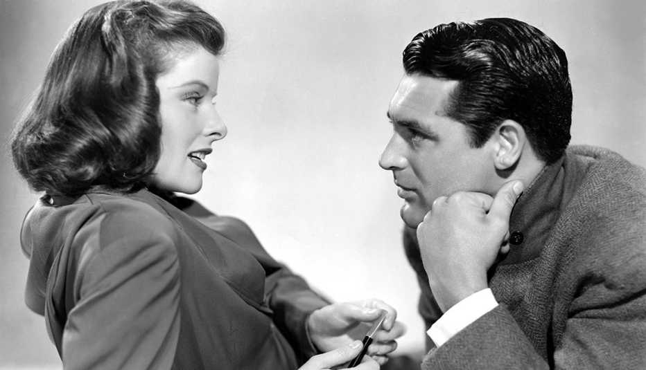 Katharine Hepburn and Cary Grant look at each other in the film Holiday