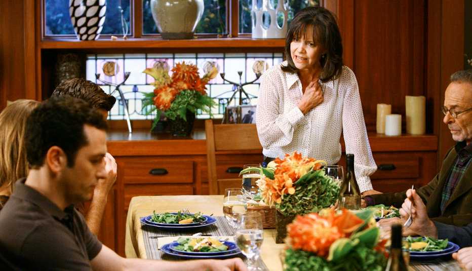Sally Field standing up at the dinner table in a scene from Brothers and Sisters."