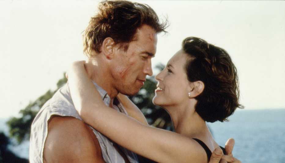 Arnold Schwarzenegger and Jamie Lee Curtis embrace in the film True Lies