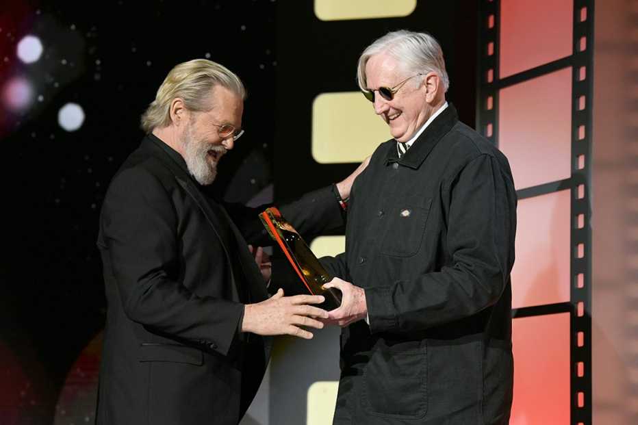 Jeff Bridges and T Bone Burnett onstage at the AARP Movies for Grownups Awards