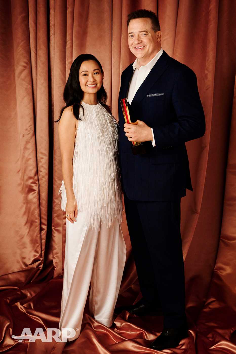Hong Chau and Brendan Fraser pose for a portrait as he holds his best actor award at the AARP Movies for Grownups Awards