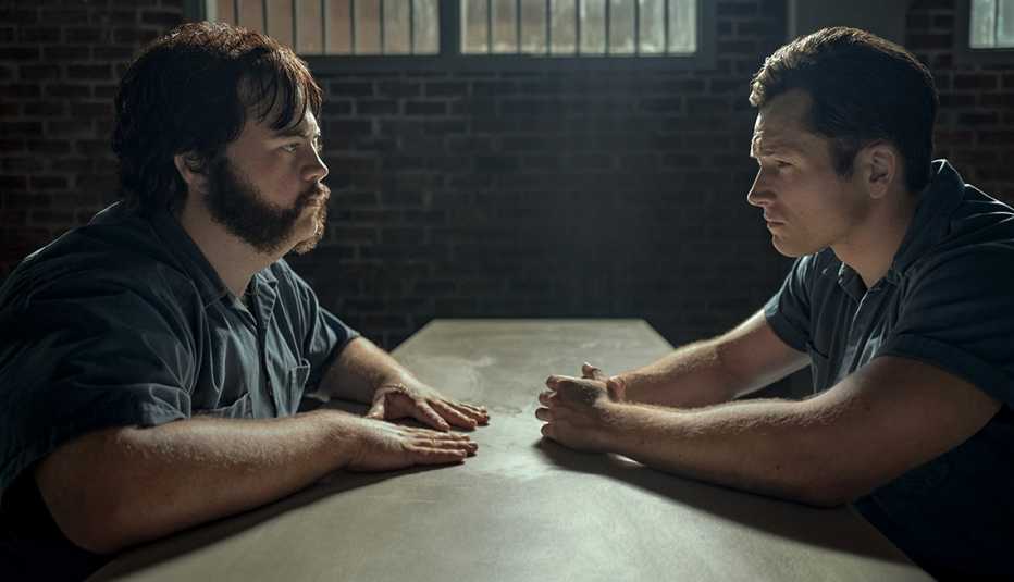 Taron Egerton and Paul Walter Hauser stare at each other in a scene in Black Bird