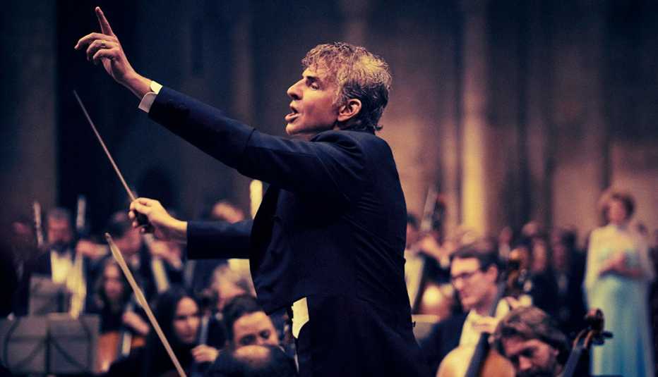 Bradley Cooper as Leonard Bernstein conducting an orchestra in the Netflix film "Maestro."