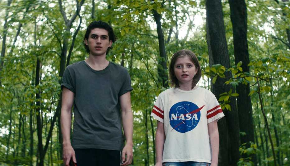 Charlie Evans and Farrah Mackenzie standing in the woods in the Netflix film "Leave the World Behind."